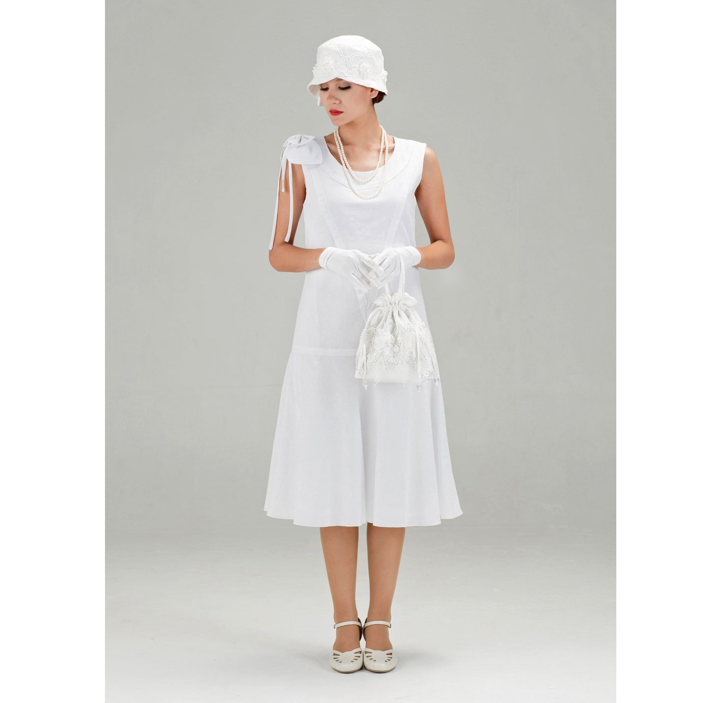 1920s high tea dress in white cotton with bow on shoulder