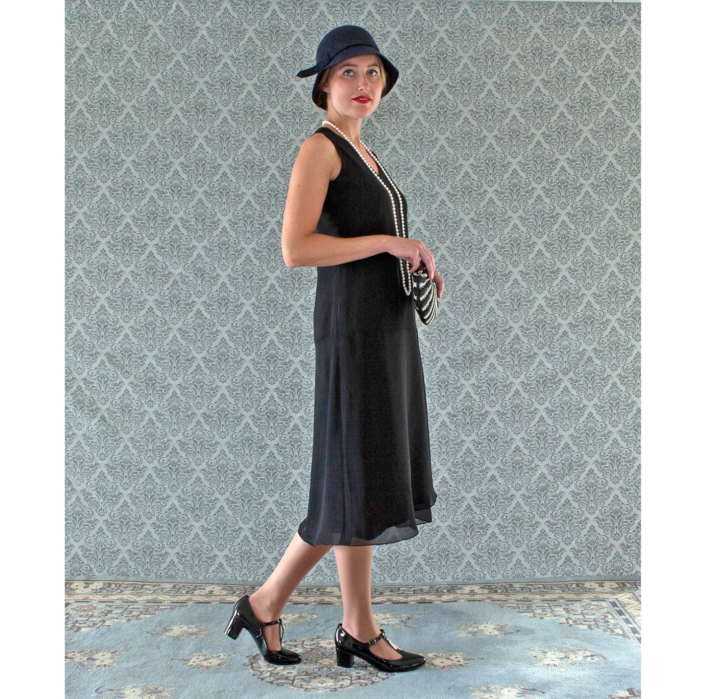 V-neck black flapper dress with drape and bow