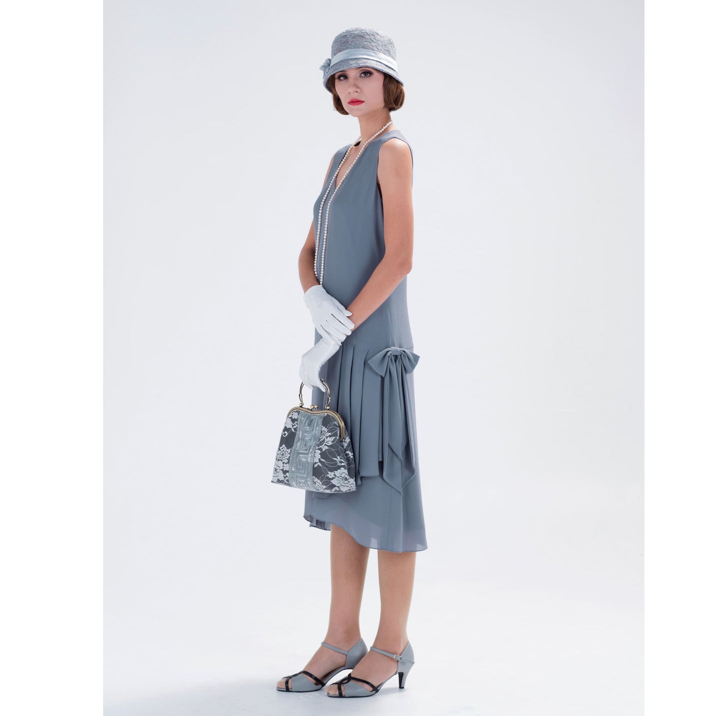 A handmade 1920s flapper dress that is made of chiffon in grey with drape and bow
