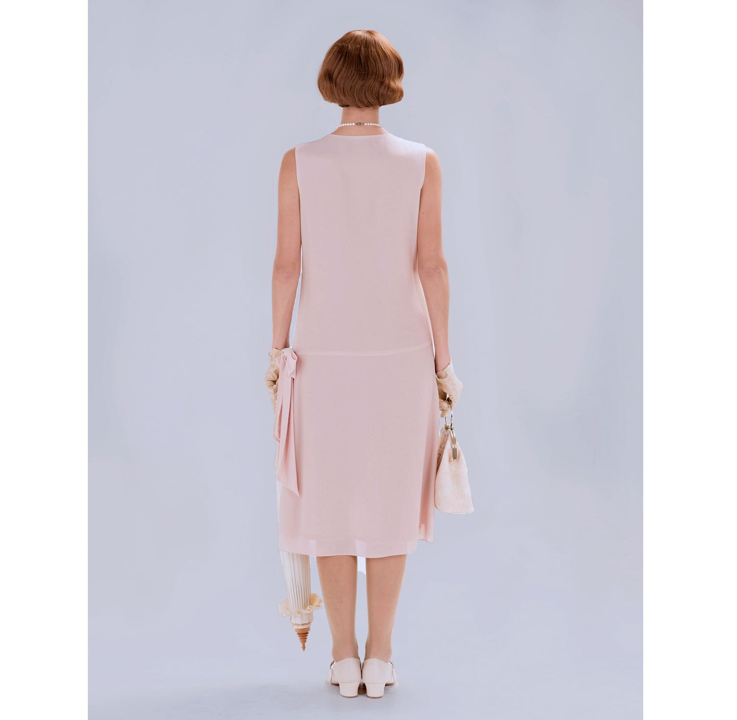 1920s flapper dress with drape and bow in nude color