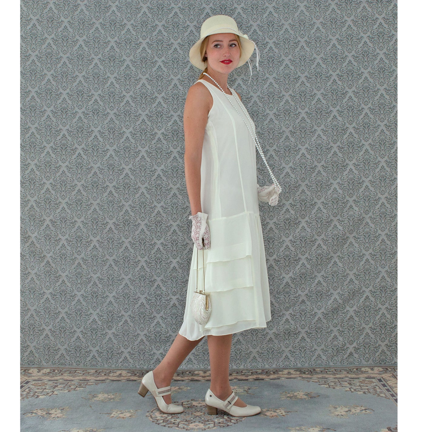 A darling roaring 20s fashion inspired chiffon dress in cream with tiered skirt