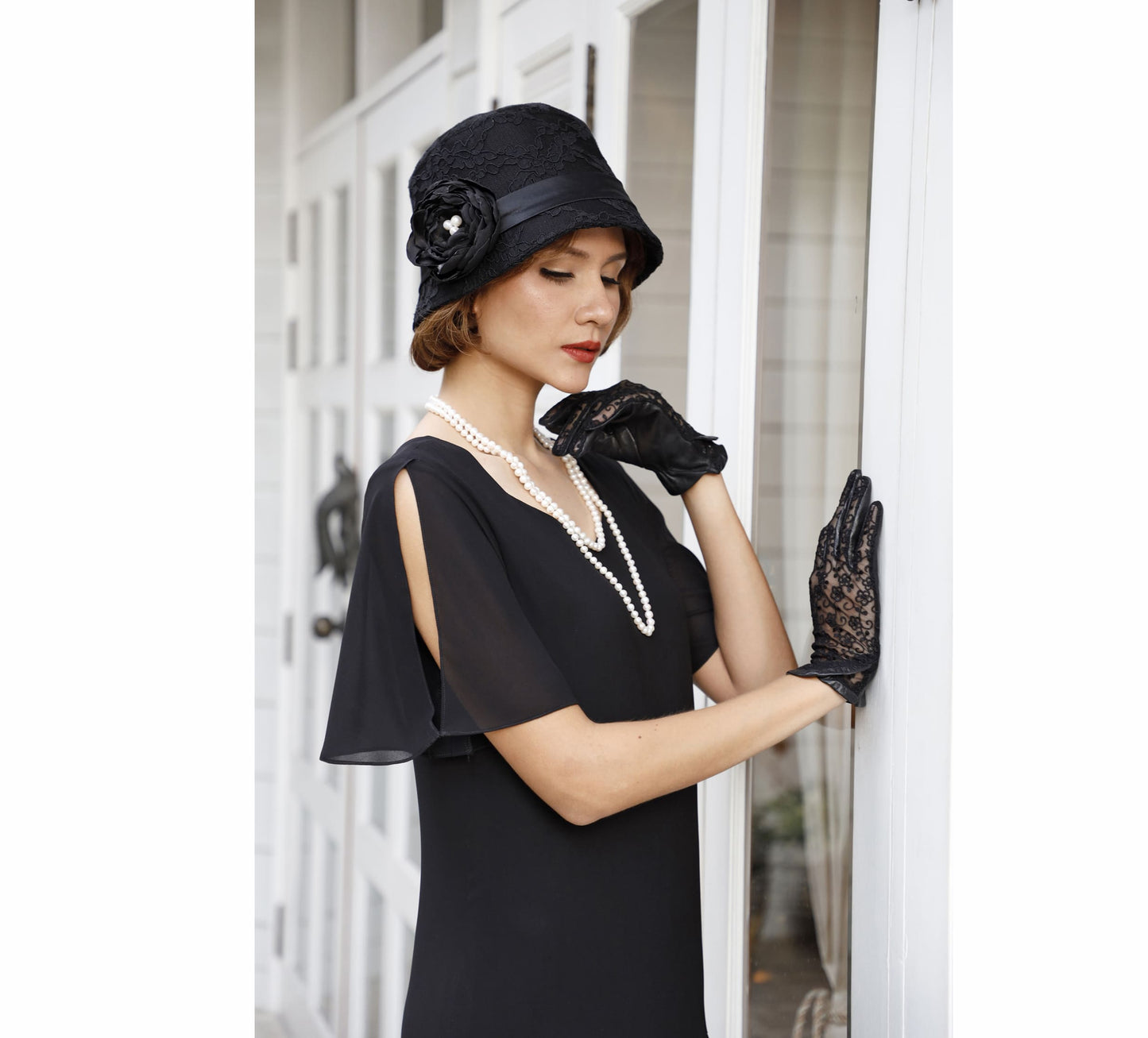 A black cotton summer cloche. This Great Gatsby hat has a lovely black lace. Also nice as a Downton Abbey hat.