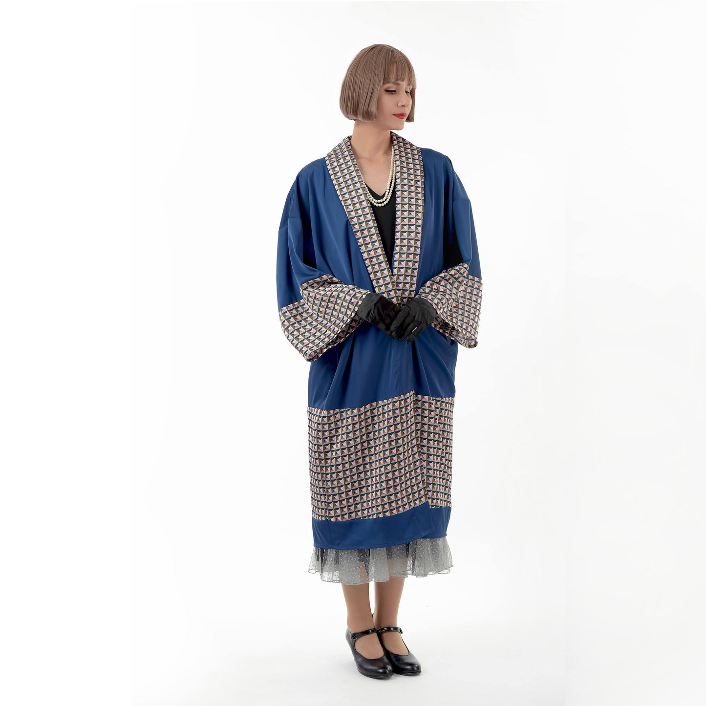 A dark blue 1920s oriental kimono robe with geometric print that can be worn as a Great Gatsby coat or a 1920s formal jacket.