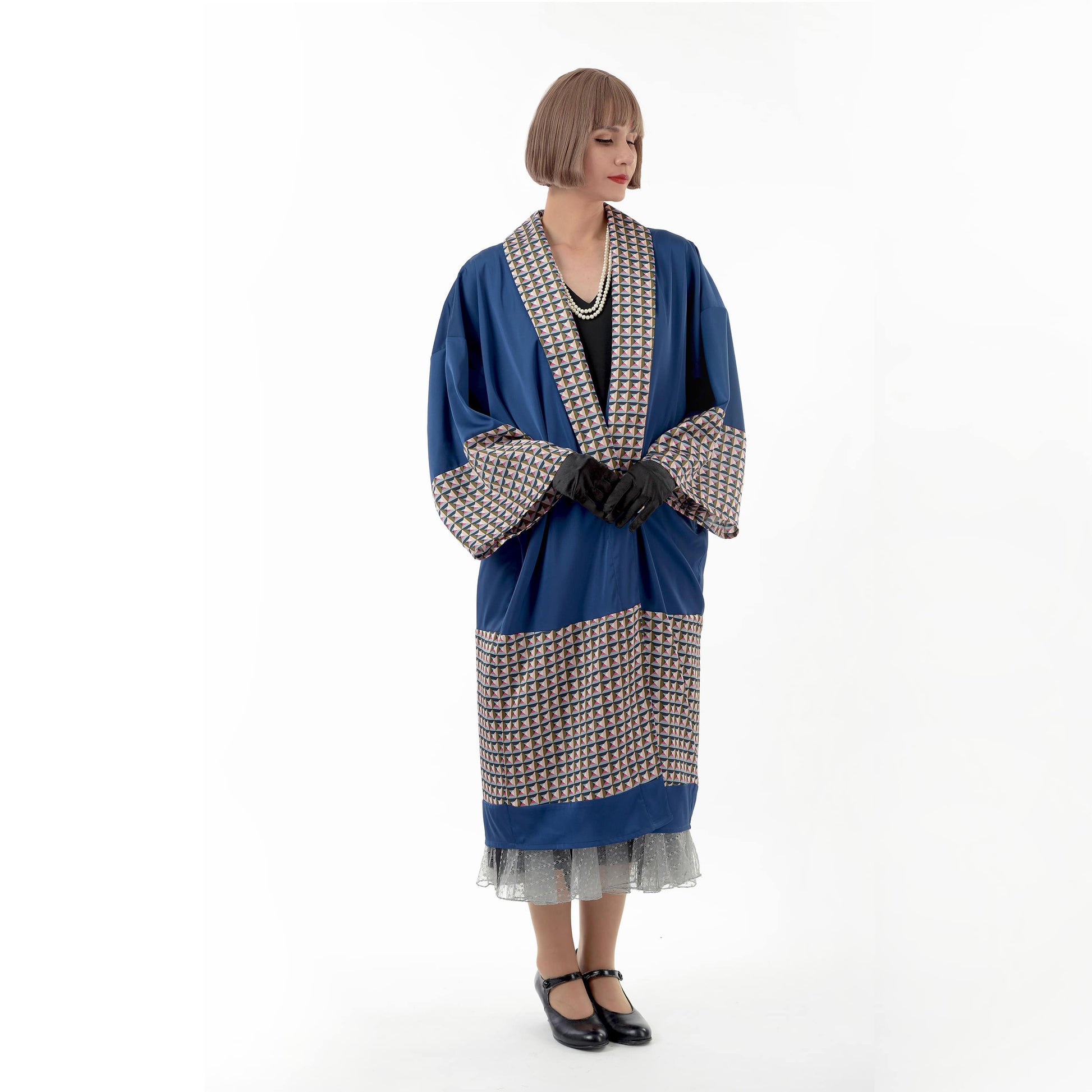 A dark blue 1920s oriental kimono robe with geometric print that can be worn as a Great Gatsby coat or a 1920s formal jacket.