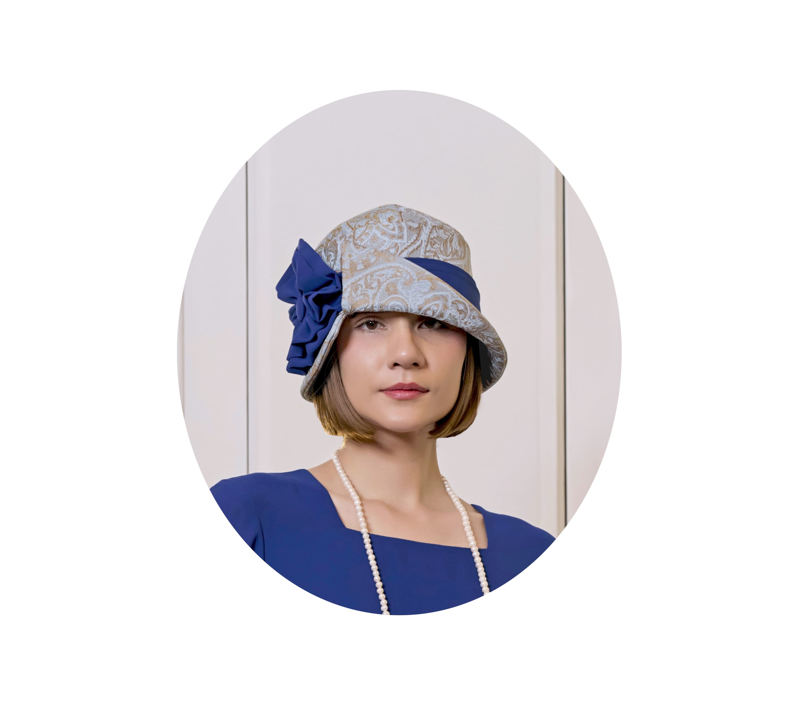 Light blue and brown cloche hat with dark blue ribbon 