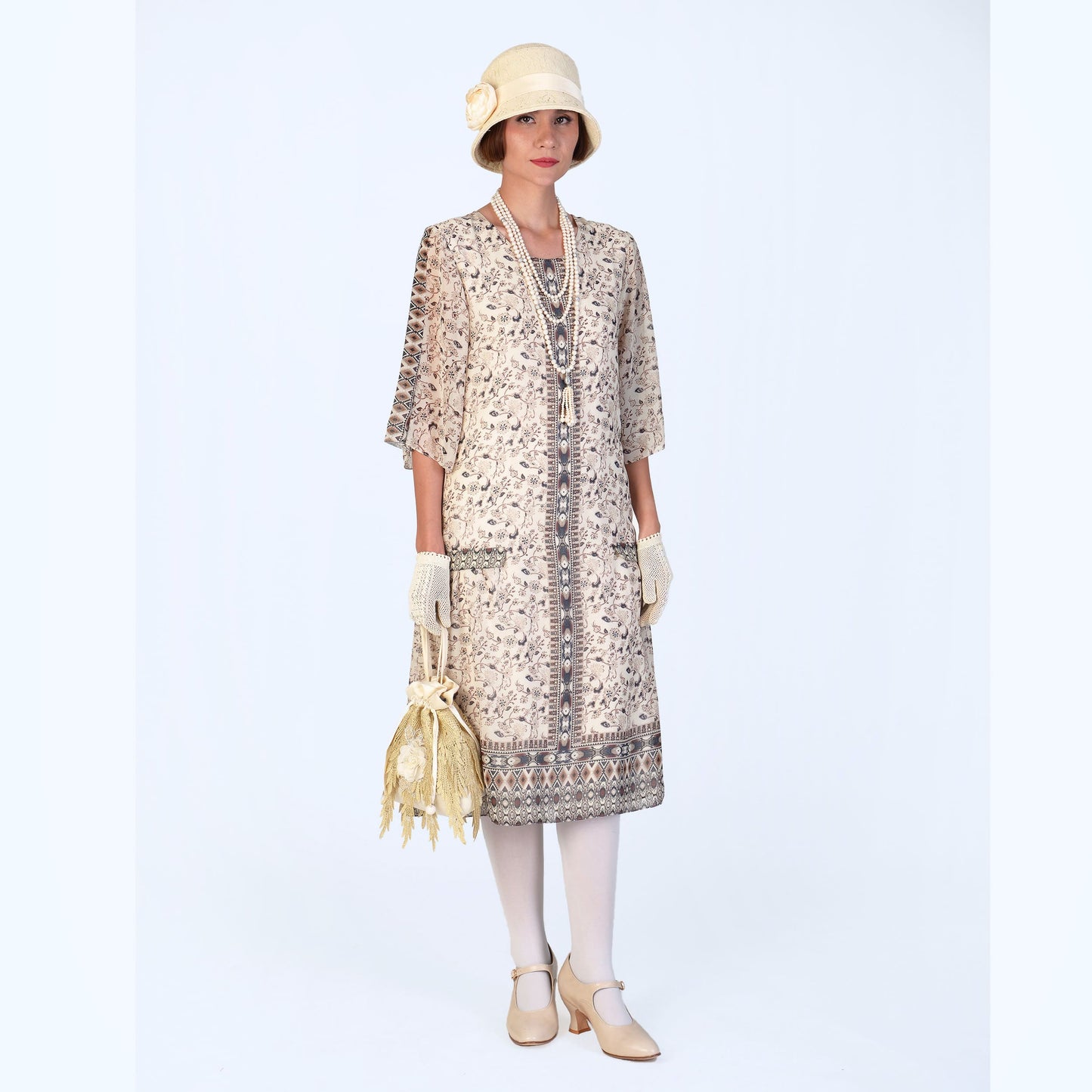 A lovely 1920s dress with elbow sleeves, made of printed cream chiffon. Suitable for 20s high tea events