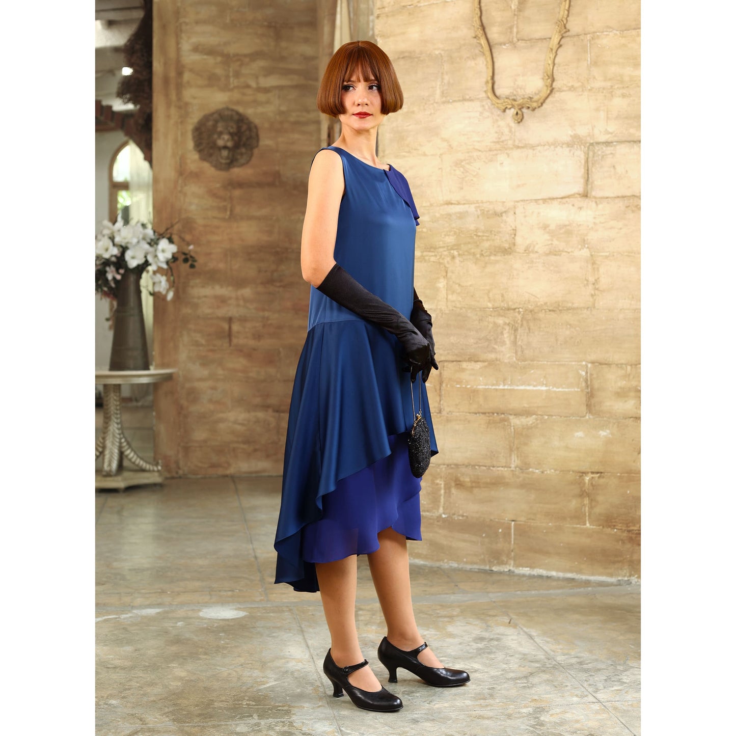 This blue satin roaring 20s evening dress with a shoulder train can be worn as a Great Gatsby evening gown or 1920s formal evening dress