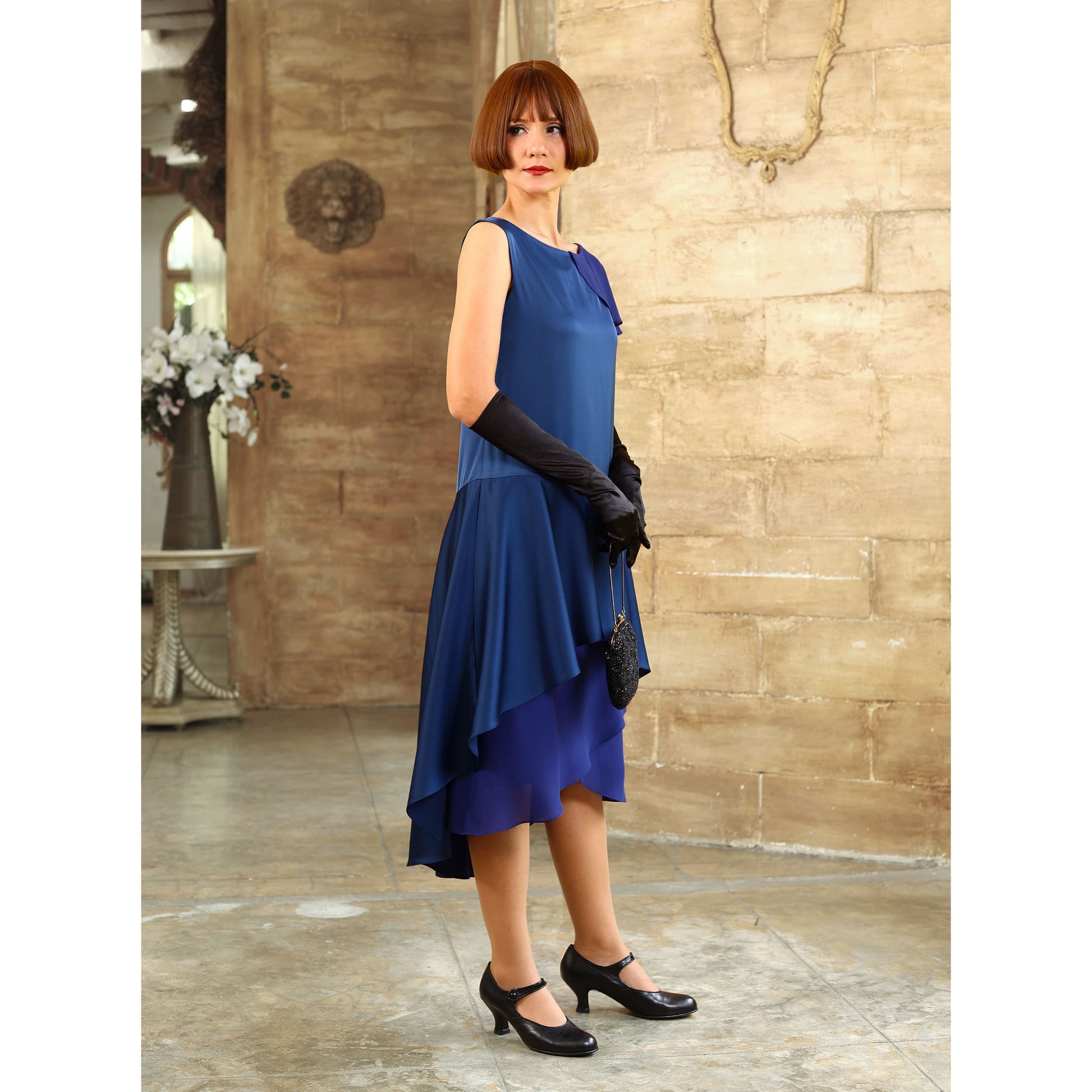 This blue satin roaring 20s evening dress with a shoulder train can be worn as a Great Gatsby evening gown or 1920s formal evening dress