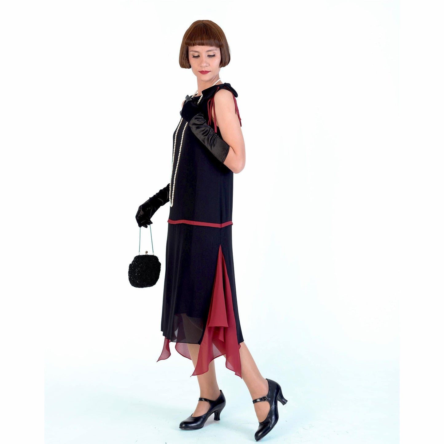 Black chiffon 1920s fashion party dress with maroon red details and shoulder bow. Can be worn as a Great Gatsby dress or Downton Abbey dress.