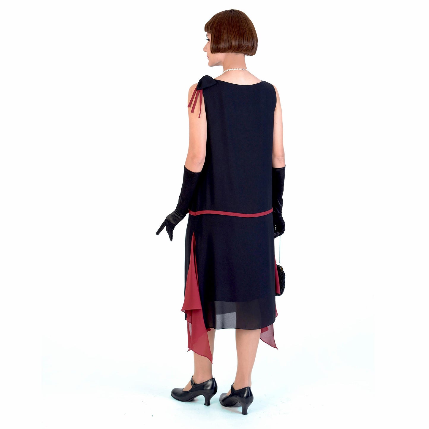 1920s black party dress with red details and shoulder bow