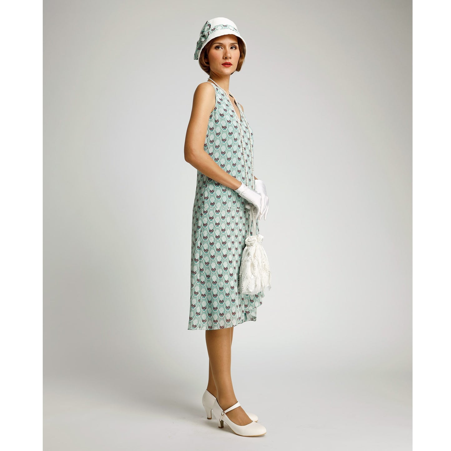 1920s day dress in green deco print with drape and bow. This 1920s fashion dress can be worn as Downton Abbey dress or Great Gatsby summer dress.