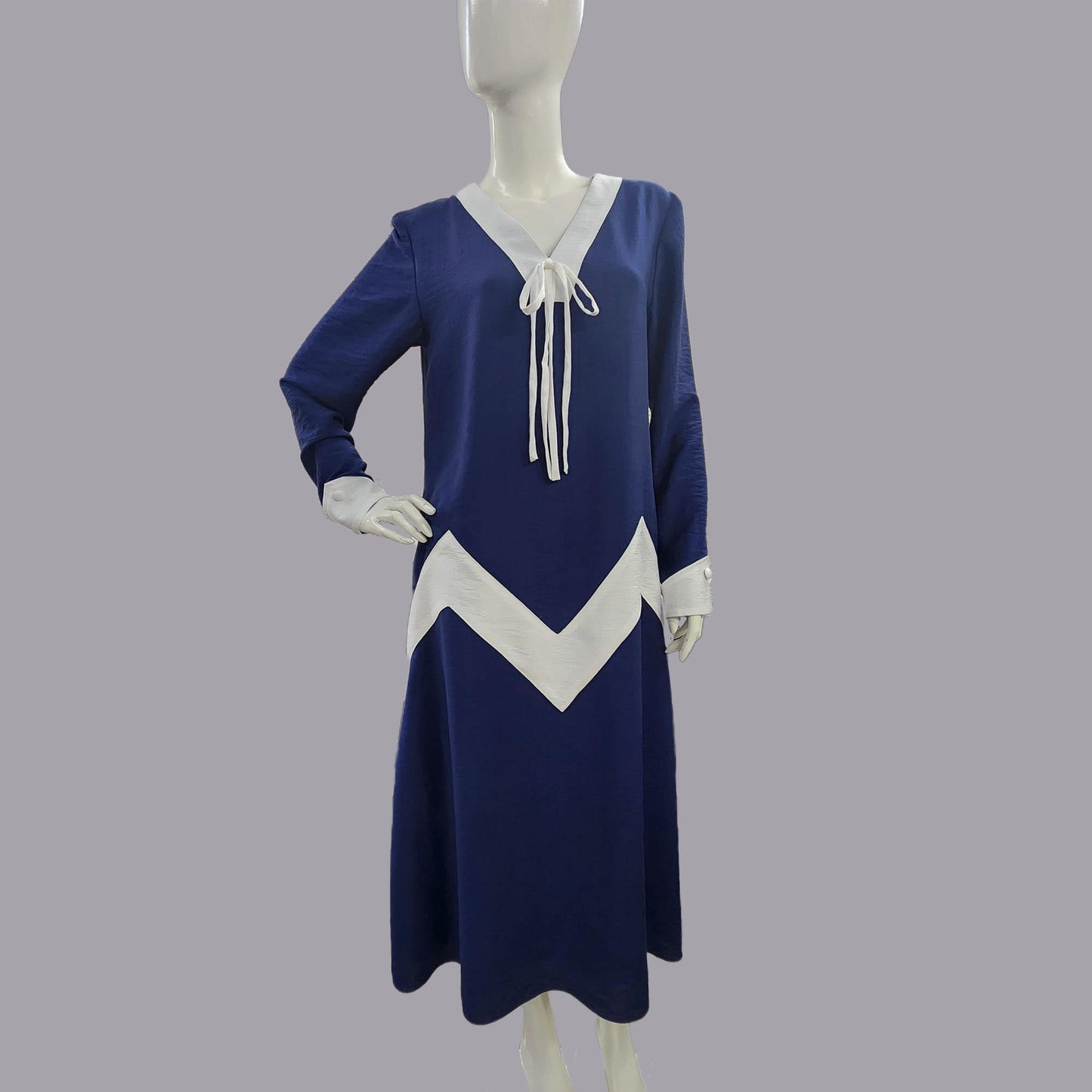 Mannequin wearing an Art Deco dress in dark blue rayon blend with white zig zag detail