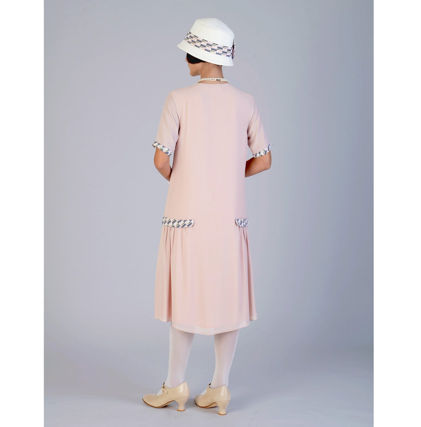 This 1920s dress made of nude chiffon fabric and contrast details with tiny blue rectangles can be worn as a Great Gatsby dress or flapper dress.