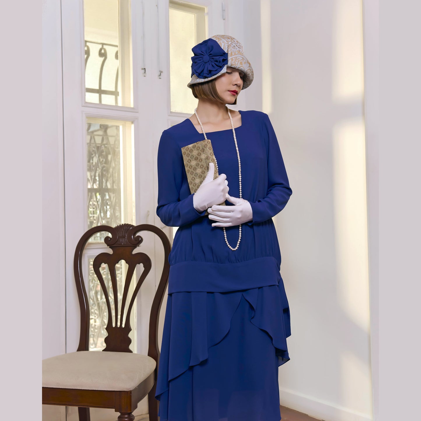 Light blue and brown cloche hat with dark blue ribbon