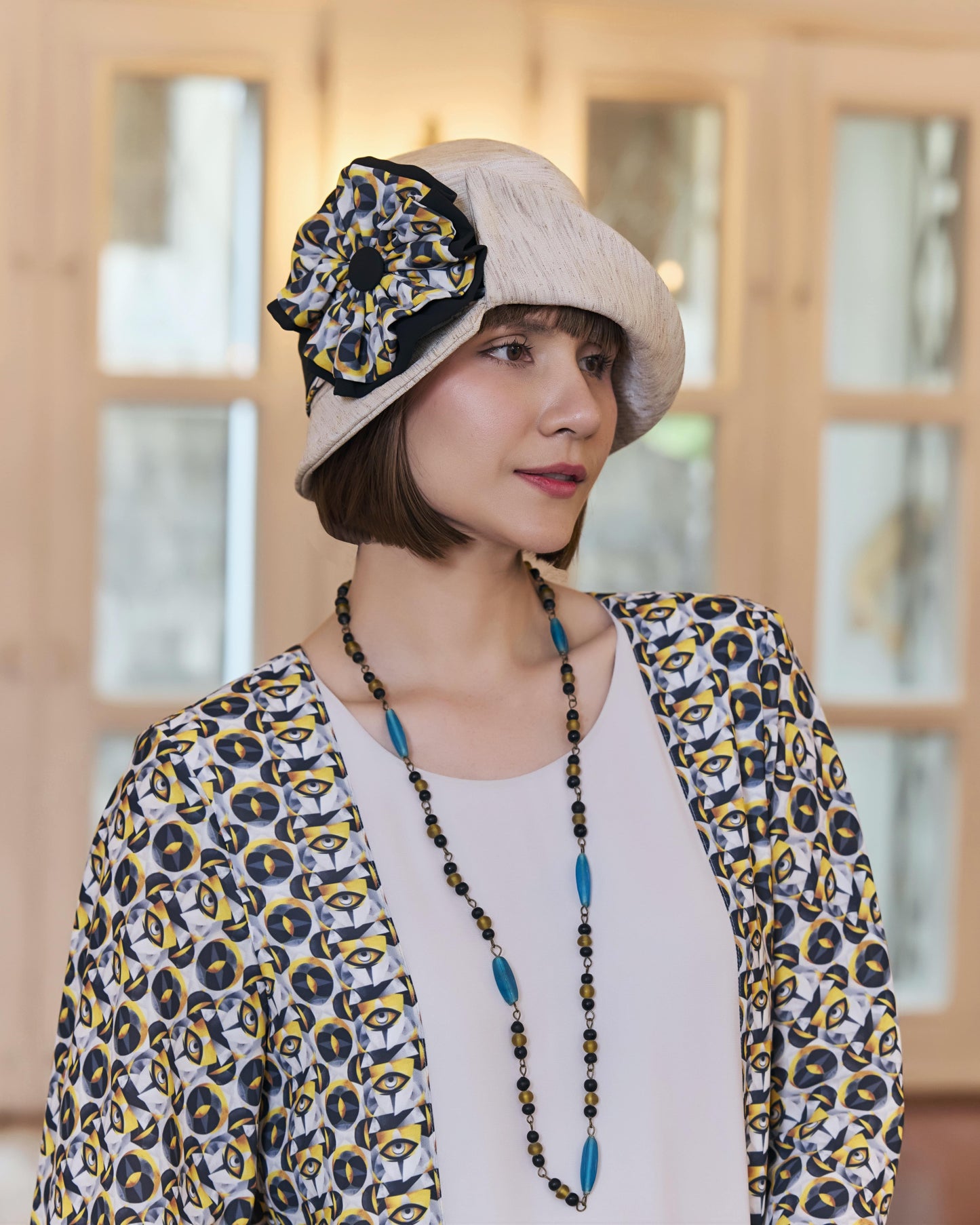 Cream Great Gatsby party hat with art deco floral hat band