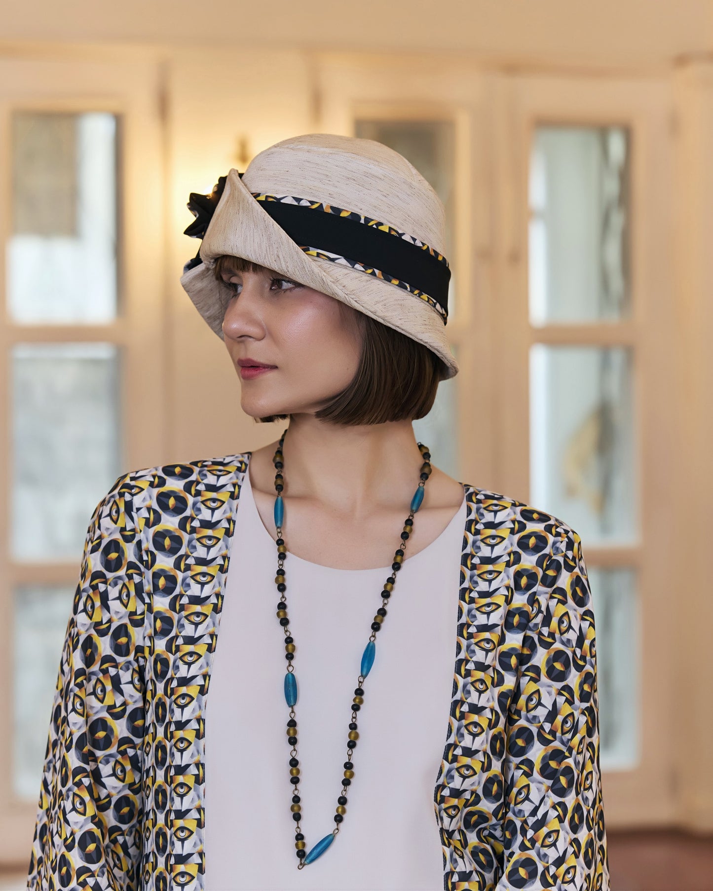Cream Great Gatsby party hat with art deco floral hat band