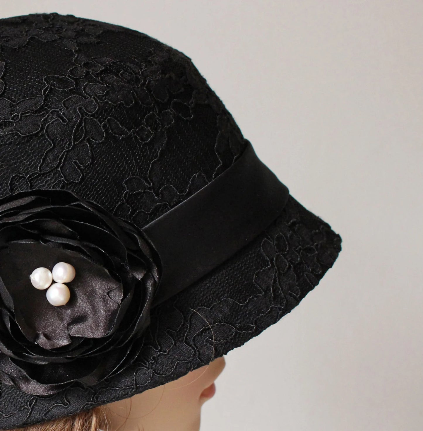 Black 1920s cloche hat with cotton and black lace
