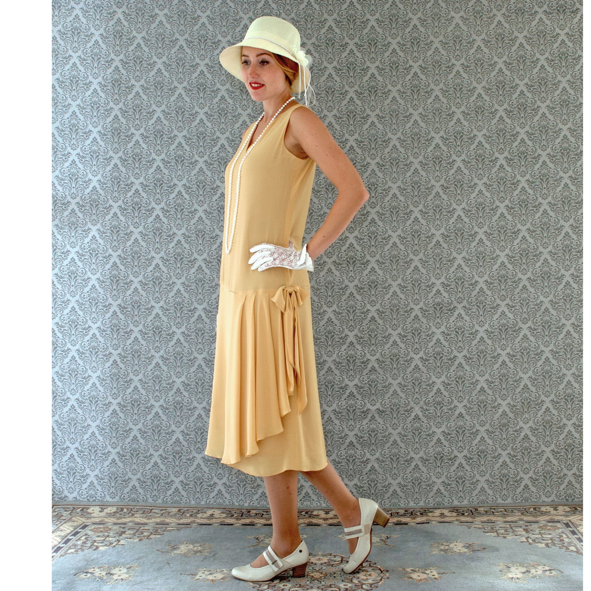 1920s-inspired flapper dress in pale marigold with drape and bow ...