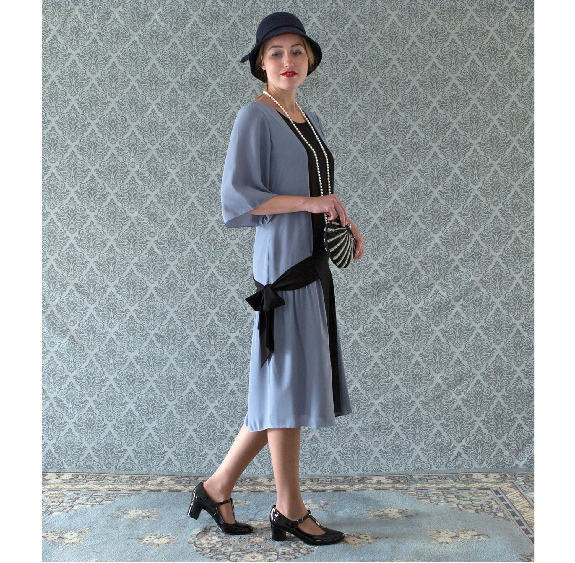 A drop-waist flapper dress inspired by art deco fashion. The 1920s dress is made of grey and black chiffon fabrics