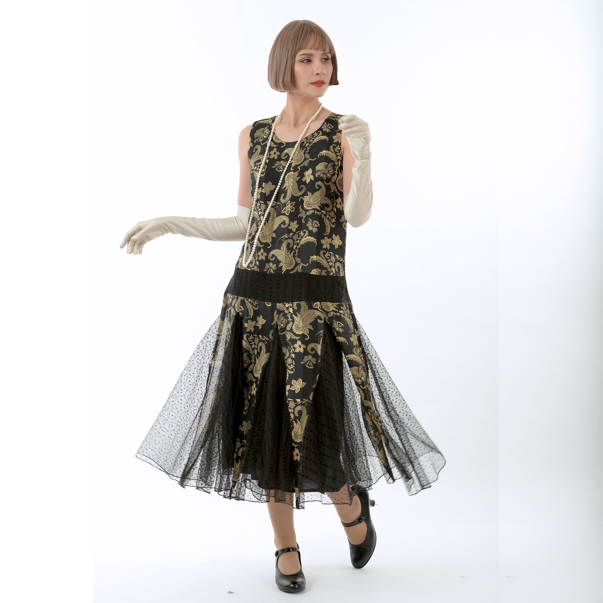 1920s evening dress in black and gold satin with black skirt godets