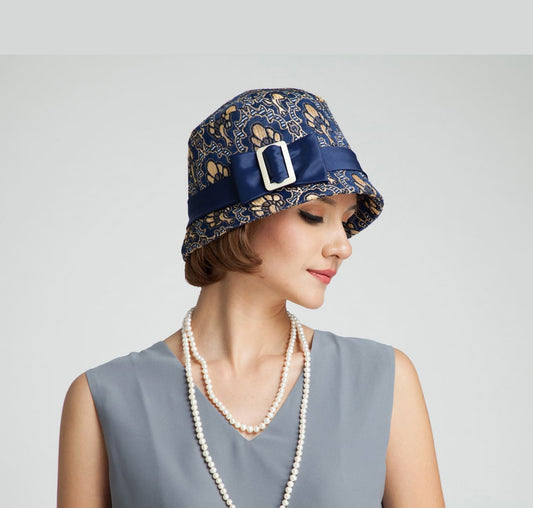 1920s cloche hat with blue and soft gold brocade fabric. This 1920s fashion hat can be worn as a Great Gatsby hat, art deco hat or flapper hat.