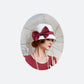 A Gatsby cloche hat made of off-white cotton decorated with maroon chiffon ribbon and lined with cream satin fabric