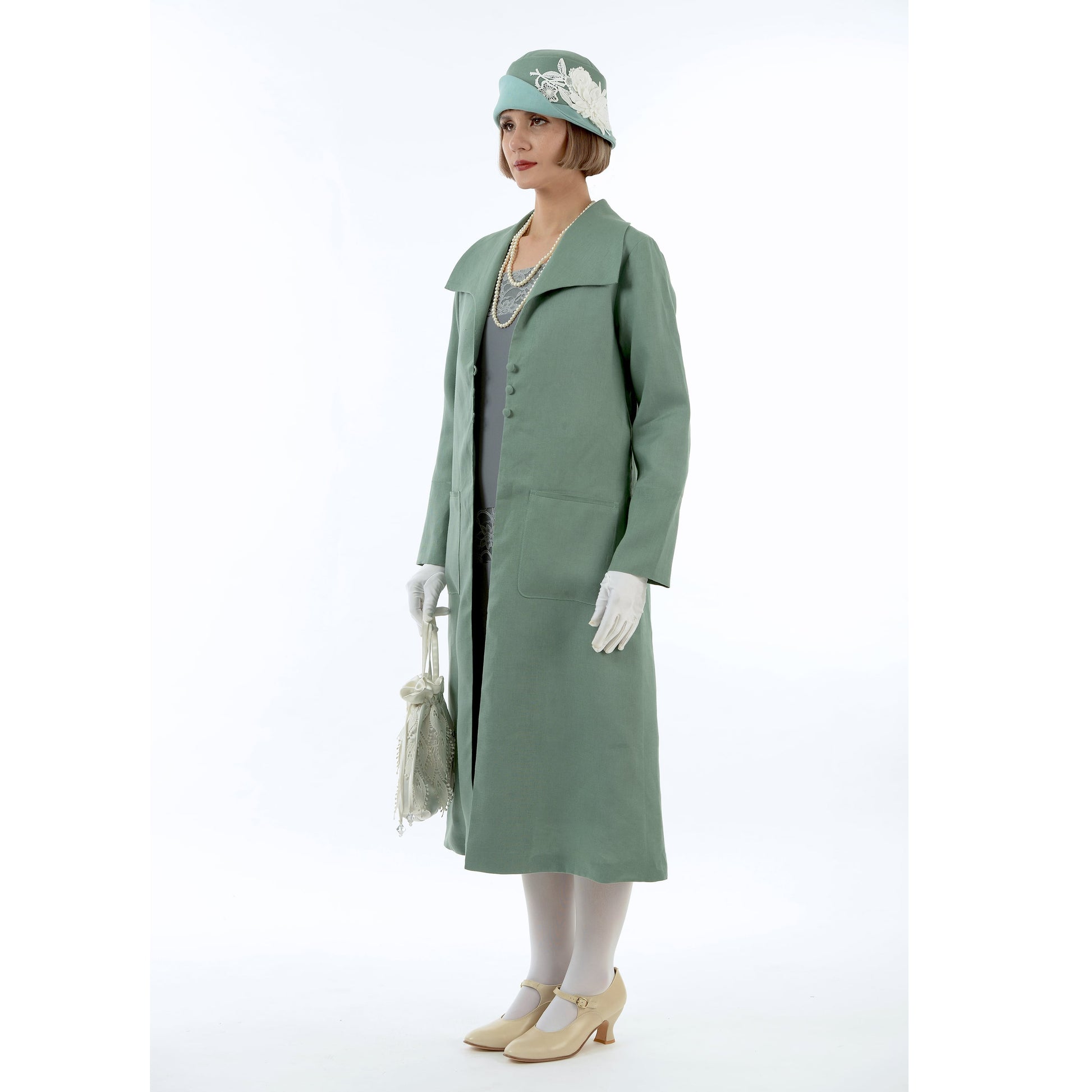 A muted green linen 1920s summer coat with wing collar that can be worn as a Great Gatsby jacket