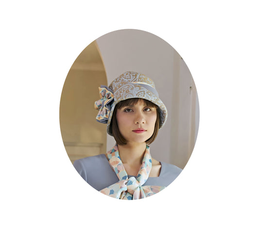Light blue and brown cloche hat with multicolored art deco print ribbon - a flapper hat