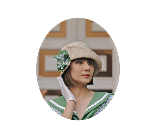 Cream cloche hat with green and white bow - a 1920s hat