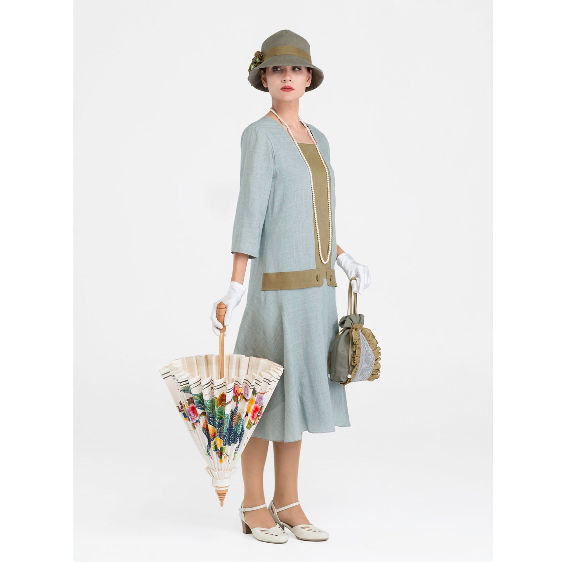 A Great Gatsby day dress made of quality linen fabric in light slate grey with olive green contrast details.