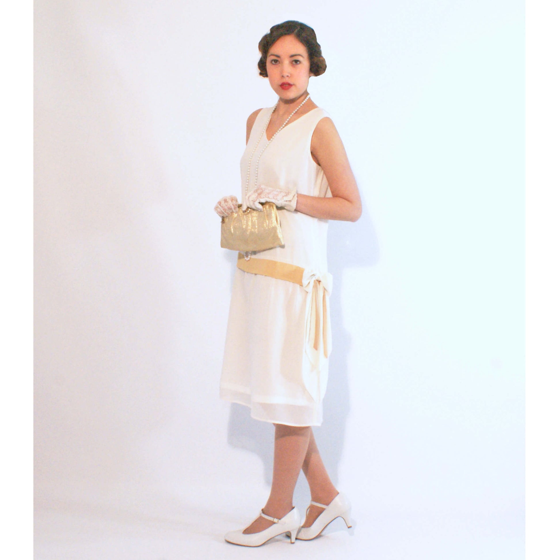 1920s inspired flapper dress made of off-white chiffon with pale marigold details - a Roaring Twenties dress