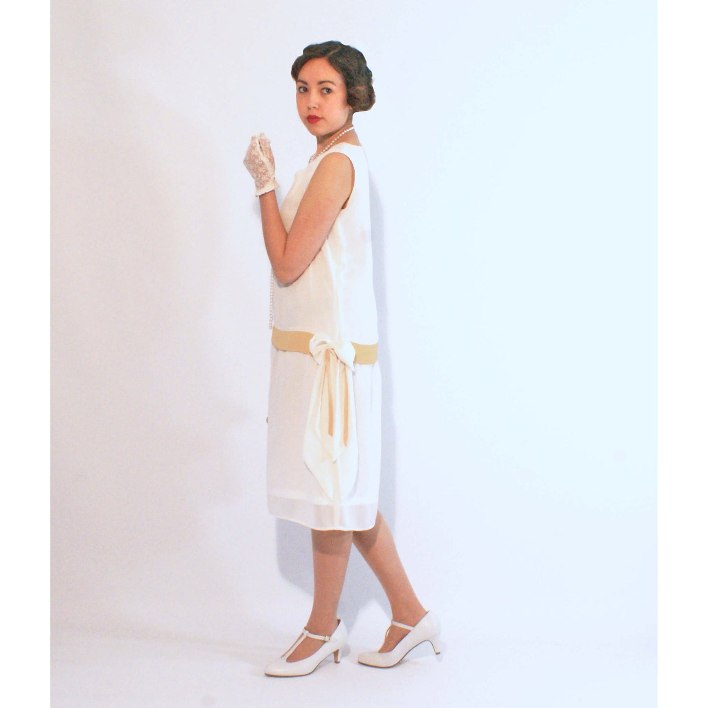 1920s inspired flapper dress made of off-white chiffon with pale marigold details