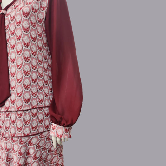 Close up of 1920s dress in red Art Deco print and maroon red contrasting details