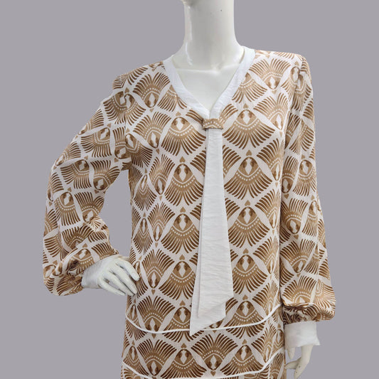 Mannequin wearing a patterned brown and white dress - an art deco dress
