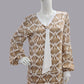Mannequin wearing a patterned brown and white dress - an art deco dress