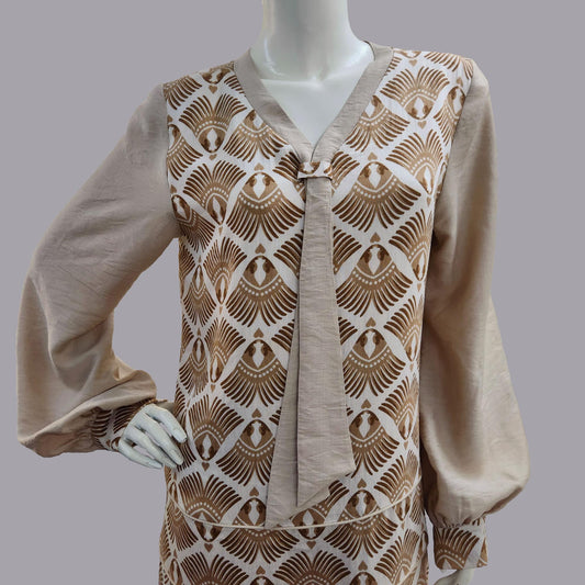 Mannequin wearing an Art Deco dress with a brown feather print pattern 