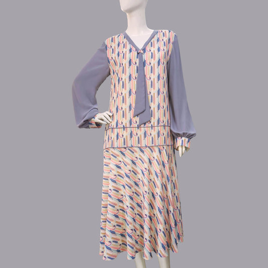 1920s fashion dress with a cheerful Art Deco pattern in light pastel shades