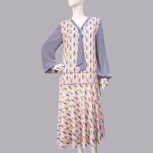 1920s fashion dress with a cheerful Art Deco pattern in light pastel shades