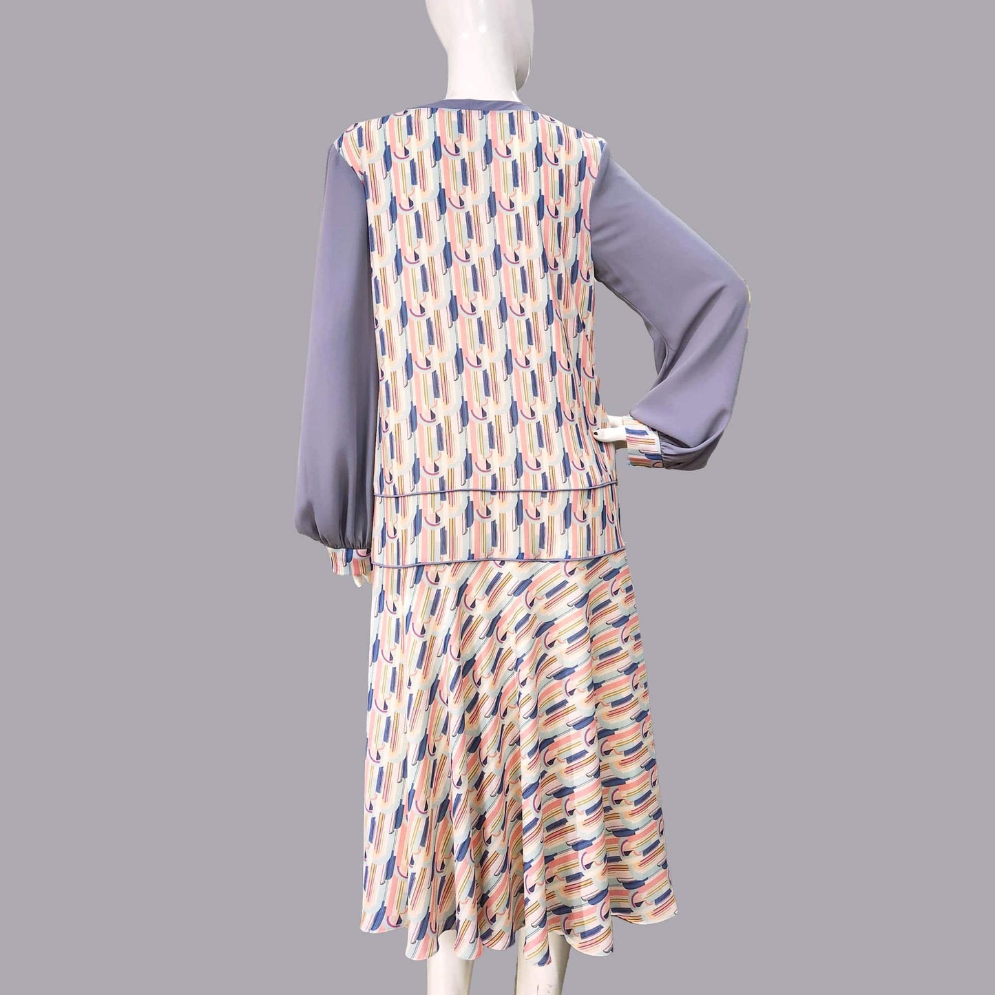 1920s fashion dress with a cheerful Art Deco pattern in light pastel shades