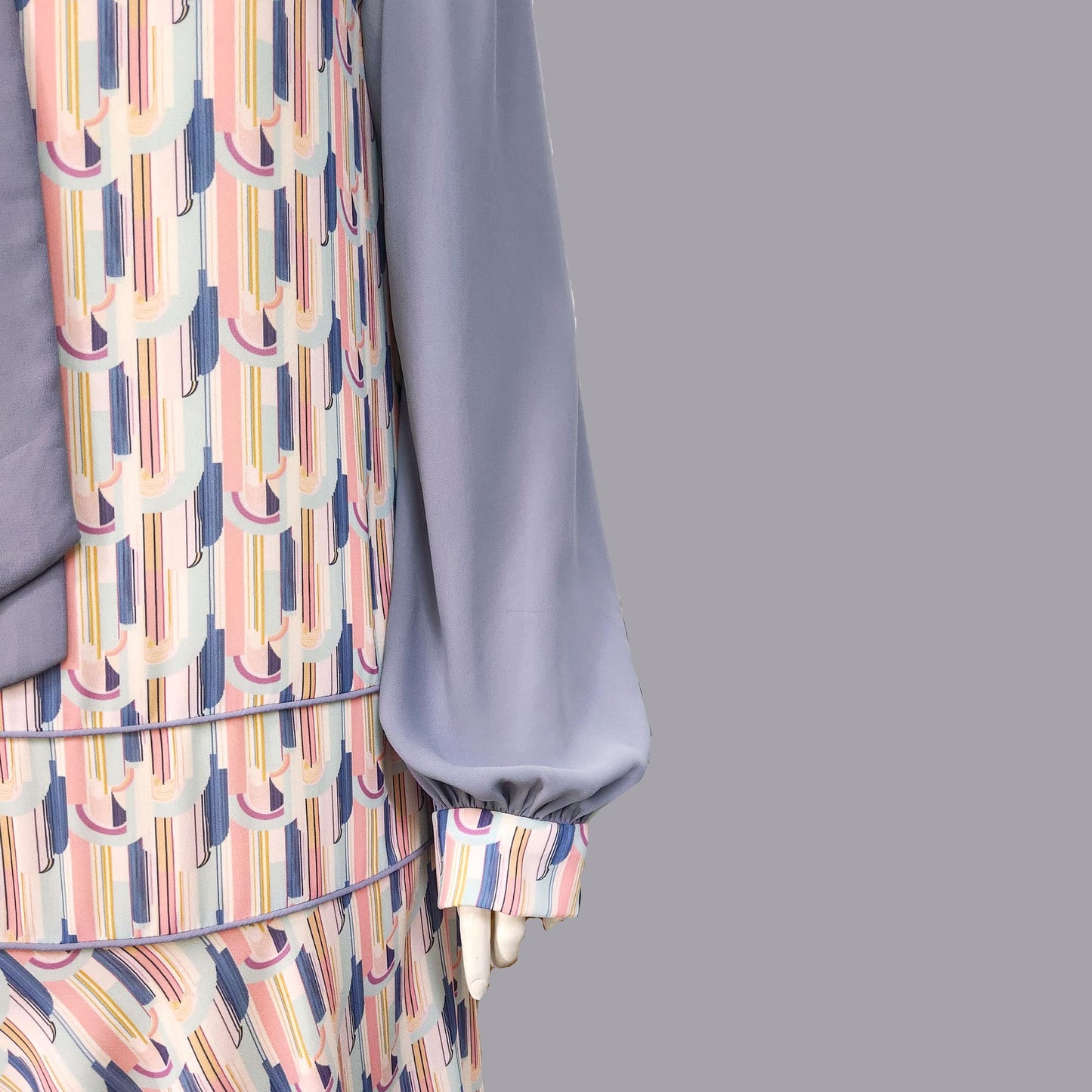 1920s fashion dress with a cheerful Art Deco pattern in light pastel shades