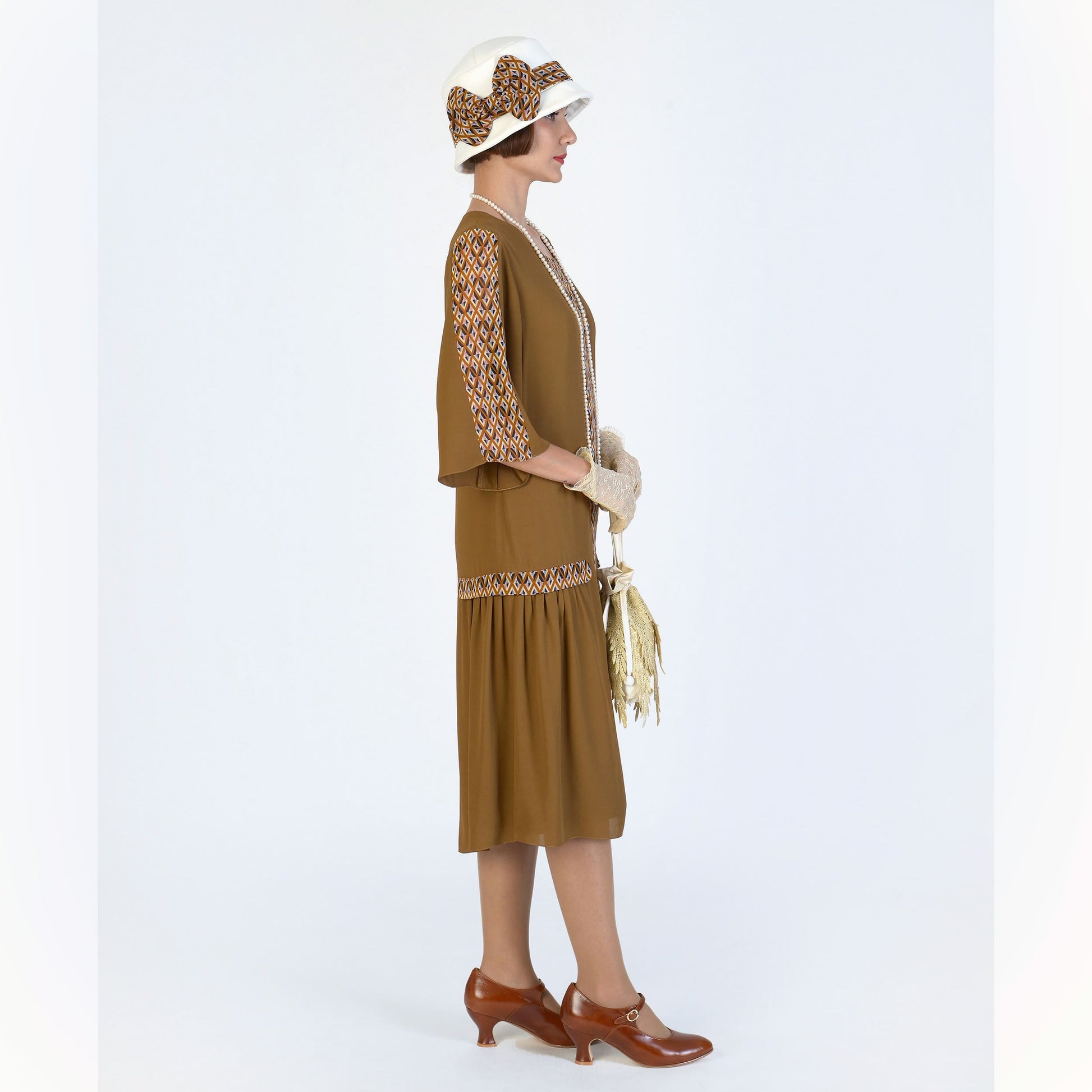 This brown roaring 20s dress, inspired by art deco fashion, can be worn as a Great Gatsby dress, flapper or Downton Abbey dress.